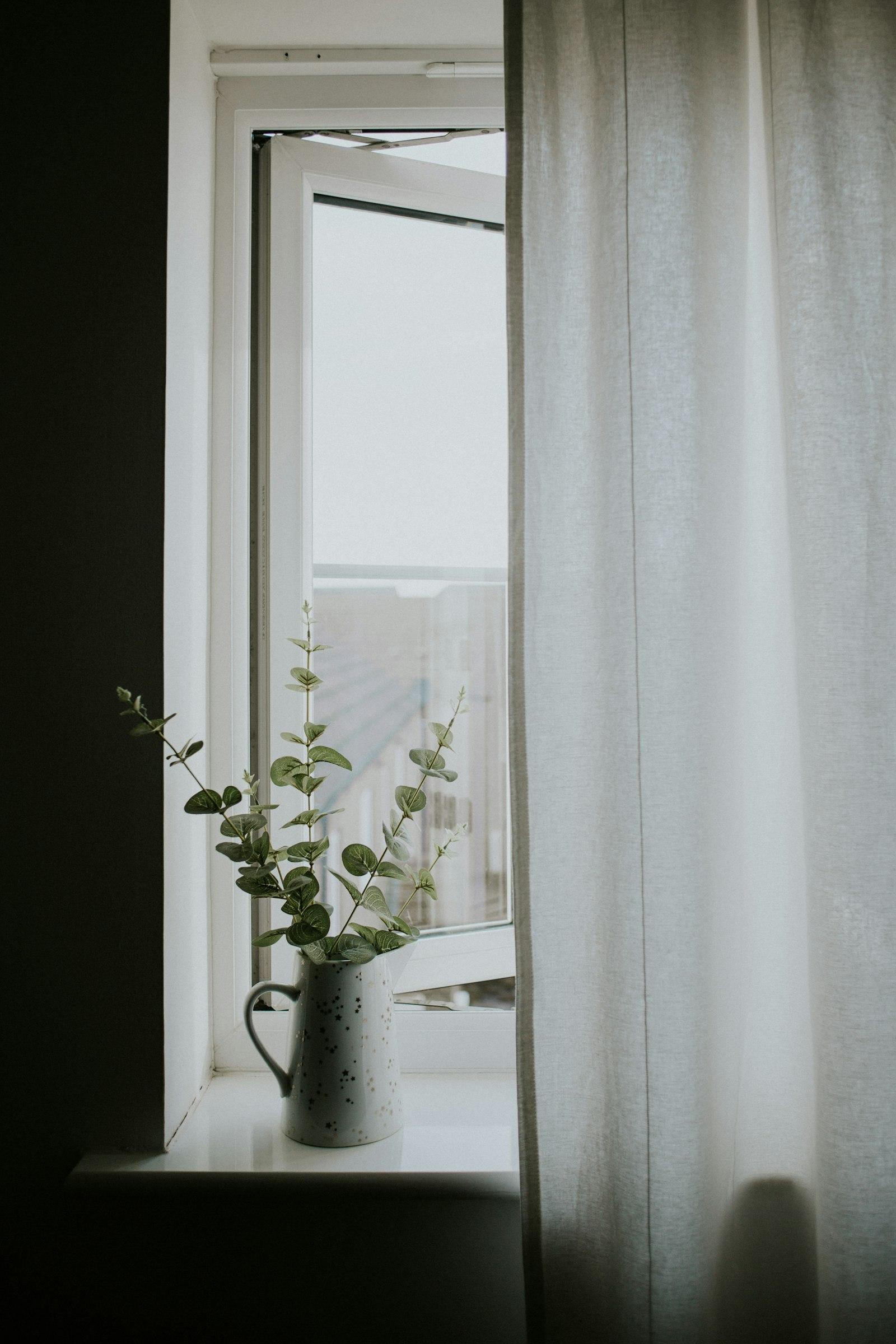 Soft morning light through linen curtains in a quiet, clean home